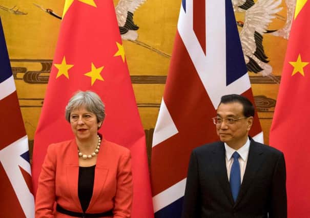 British Prime Minister Theresa May (L) and Chinese Premier Li Keqiang attend a signing ceremony at the Great Hall of the People in Beijing. Picture: Getty Images