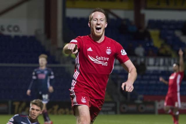 Aberdeen's Adam Rooney celebrates as he makes it 3-0. Picture: SNS