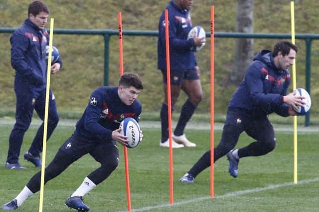Matthieu Jalibert, left, runs with the ball during a France training session. Picture: Michel Euler/AP