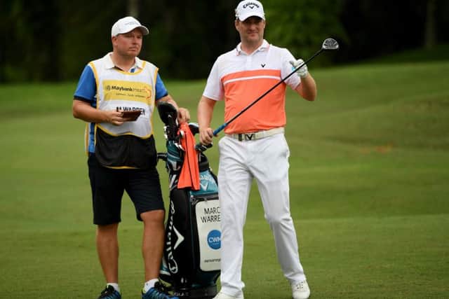 Marc Warren sizes up a shot at the 18th on his way to a six-under-par 66 in the second round of the Maybank Championship in Malaysia. Picture: Getty Images