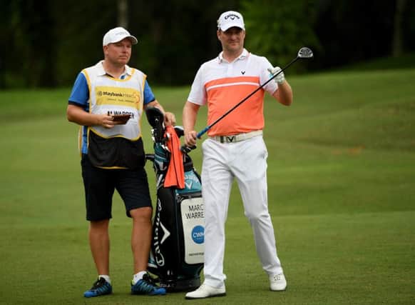 Marc Warren sizes up a shot at the 18th on his way to a six-under-par 66 in the second round of the Maybank Championship in Malaysia. Picture: Getty Images