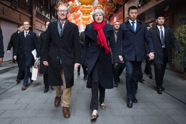 Theresa May and her husband Philip walk through a market after visiting the Yu Yuan Temple Garden in Shanghai. Picture: Stefan Rousseau/PA Wire