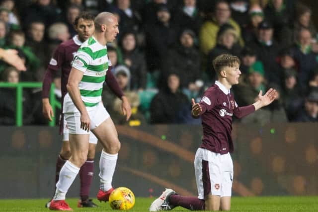 Celtic's Scott Brown clashes with Hearts' Harry Cochrane. Picture: Ross MacDonald/SNS