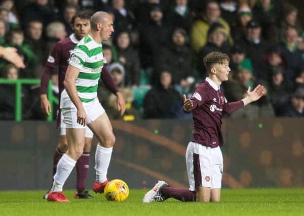 Celtic's Scott Brown clashes with Hearts' Harry Cochrane. Picture: Ross MacDonald/SNS