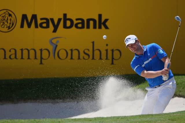Marc Warren splashes out of a bunker at the eighth hole in the final round of the Maybank Championship. Picture: Getty Images