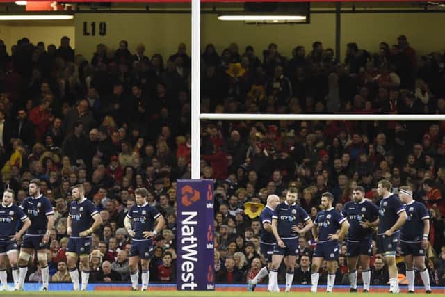 Scotland players look dejected as they wait for Leigh Halfpenny to slot over another conversion. Picture: Ian Rutherford