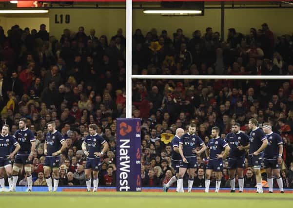 Scotland players look dejected as they wait for Leigh Halfpenny to slot over another conversion. Picture: Ian Rutherford