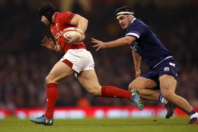Stuart McInally chases after Wales' Leigh Halfpenny during Saturday's match. Picture: PA