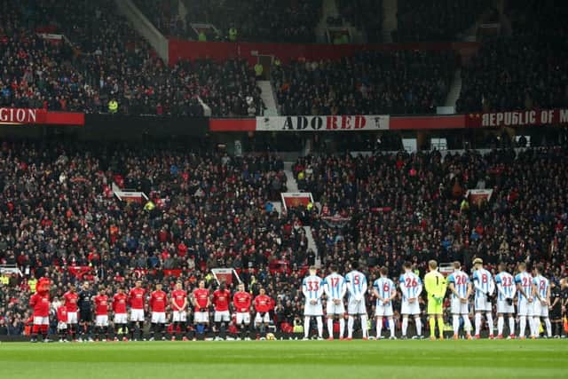 Players of Manchester United and Huddersfield Town line up for a minutes silence in tribute to victims of the Munich air disaster ahead of the Premier League match at Old Trafford last Saturday. Picture: PA.