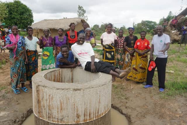 Members of the Kaporo Smallholder Farmers Association, who grow Kilombero rice, gather round a new well supported by JTS credit. Picture: Contributed