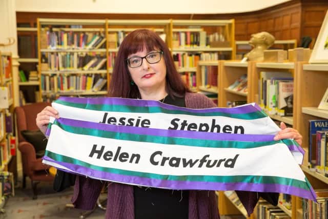 Donna Moore at the Glasgow Women's Library in Bridgeton, Glasgow with sashes commemorating the names of Jessie Stephen and Helen Crawfurd.  Picture: Robert Perry/TSPL