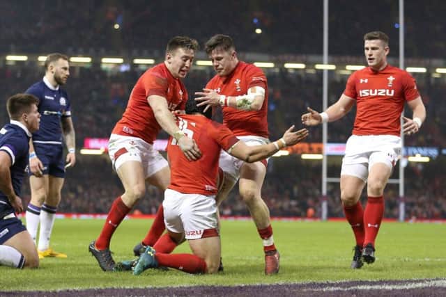 Leigh Halfpenny celebrates after scoring Wales second try during their impressive win over Scotland. Picture: PA.