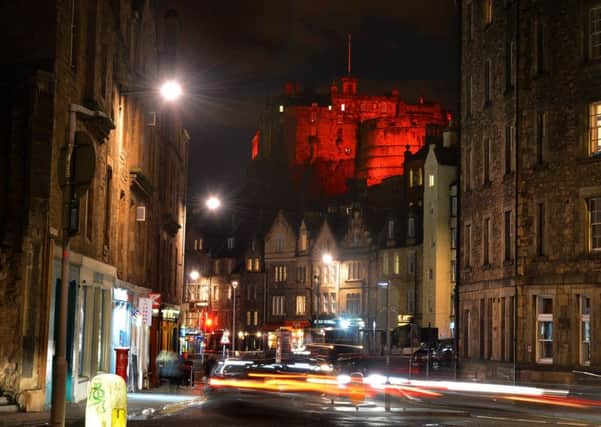 Edinburgh castle bathed in red light. Picture: Jon Savage