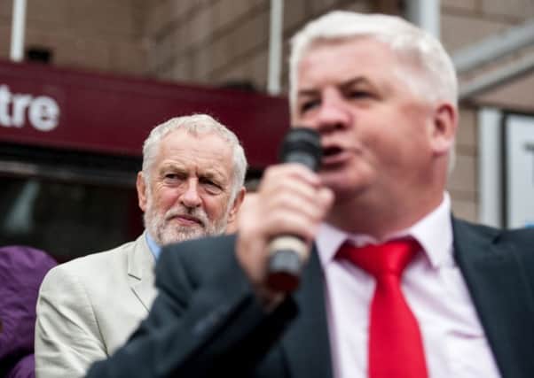 Hugh Gaffney MP campaigning in Coatbridge last year with Jeremy Corbyn behind. Picture John Devlin.