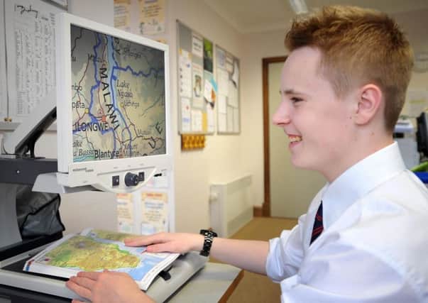 Scott Hilson,16, a pupil at the Royal Blind School, Edinburgh, uses a video magnifier machine. (Picture: Jane Barlow)