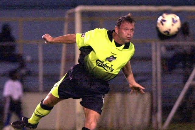 Hibs were guilty of some shocking away kits in the Nineties, like this one sported by John Hughes. Picture: TSPL