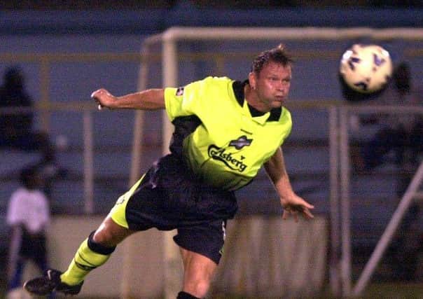 Hibs were guilty of some shocking away kits in the Nineties, like this one sported by John Hughes. Picture: TSPL