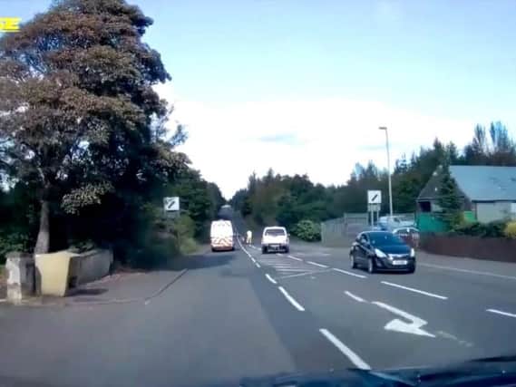 A car overtook a van just where the workman was painting road markings. Picture: Vimeo