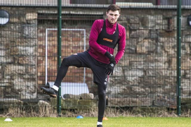 Hearts defender John Souttar limbers up yesterday as he prepares to face St Johnstone. Picture: SNS.