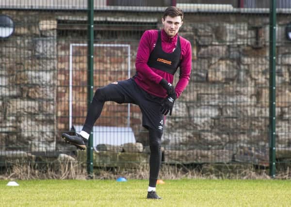 Hearts defender John Souttar limbers up yesterday as he prepares to face St Johnstone. Picture: SNS.