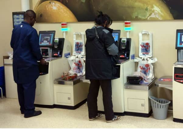 Self-service supermarket tills are replacing checkout staff.  Photo by Jeff Blackler/Rex/Shutterstock