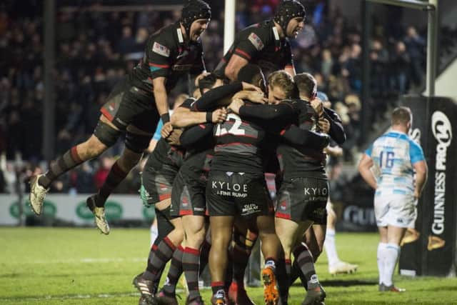 Mark Bennett is mobbed by his team-mates after his late try clinched a dramatic win for Edinburgh. Picture: SNS/SRU