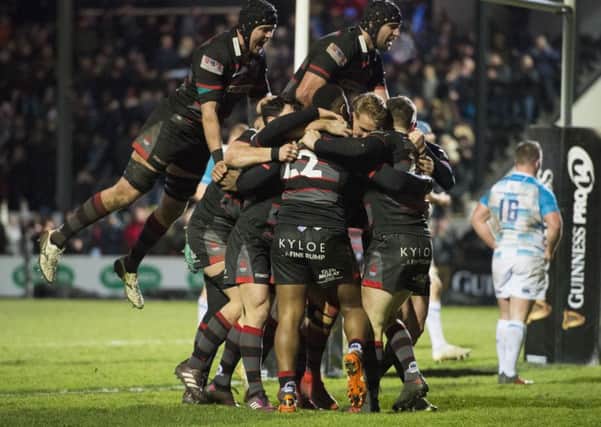 Mark Bennett is mobbed by his team-mates after his late try clinched a dramatic win for Edinburgh. Picture: SNS/SRU