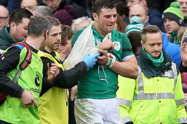 Ireland's centre Robbie Henshaw is helped from the field during their clash with Italy