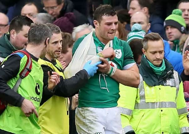 Ireland's centre Robbie Henshaw is helped from the field during their clash with Italy