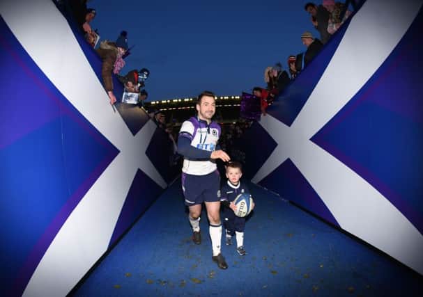 Scotland's Greig Laidlaw with his son at full time. Picture: SNS