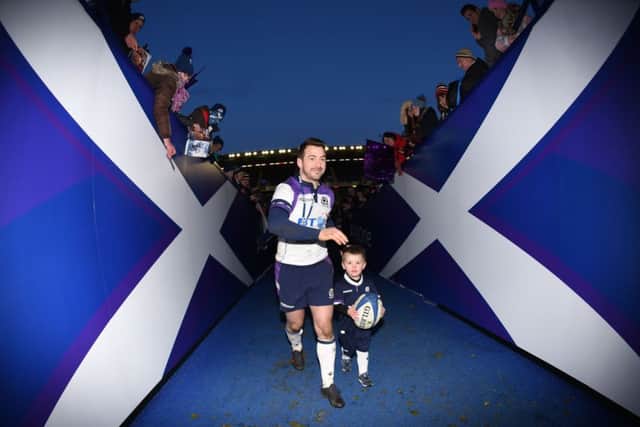 Scotland's Greig Laidlaw with his son at full time. Picture: SNS