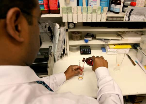 Medicine being measured out in a high street pharmacy. Picture: Anthony Devlin/PA Wire