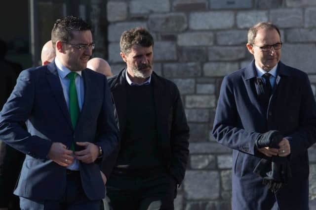 Roy Keane (centre) and Martin O'Neill (right) arrive for the funeral of former Celtic and Manchester United footballer Liam Miller. Picture: PA