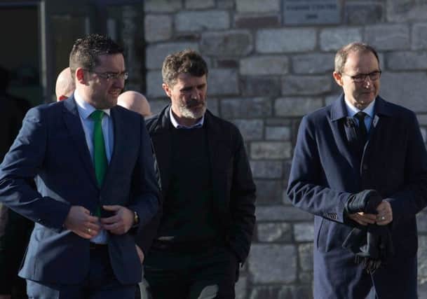Roy Keane (centre) and Martin O'Neill (right) arrive for the funeral of former Celtic and Manchester United footballer Liam Miller. Picture: PA