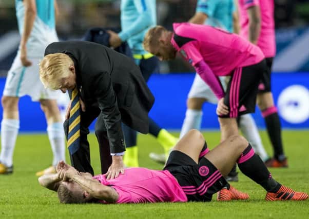 Gordon Strachan consoles Leigh Griffiths after the 2-2 draw against Slovenia ended Scotland's hopes of reaching the World Cup finals in Russia this summer.