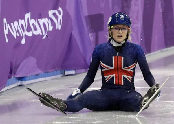 Elise Christie of Britain sits on the ice after crashing during the 500 meters short-track speedskating final (Picture: AP)