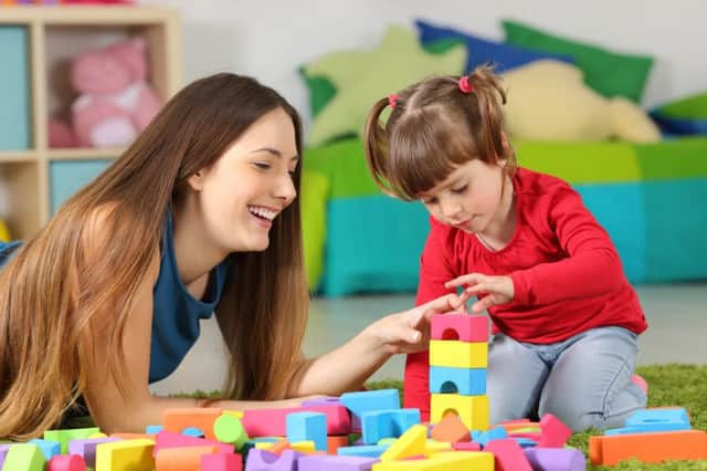 A mother and daughter play with toys in their home. The Scottish Governments ambitious policy to double early learning and childcare hours by 2020 has sparked warnings