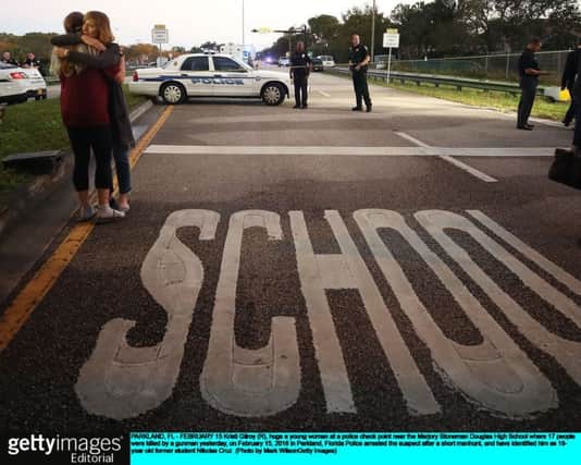 High school students embrace after America's latest mass shooting