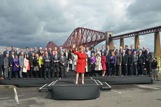 First Minister Nicola Sturgeon MSP joins the newly elected SNP MPs for a photo-call with a background of the Forth Bridge at South Queensferry,