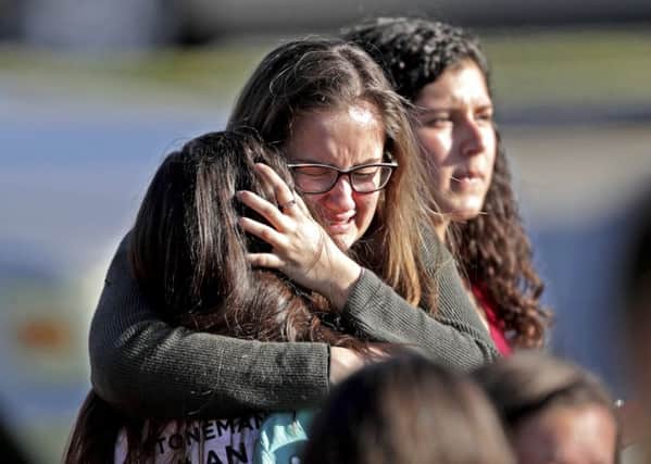 Students released from a lockdown embrace following following a shooting at Marjory Stoneman Douglas High School in Parkland, Picture; AP