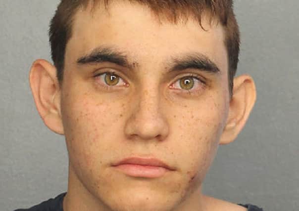 Custody image of Nikolas Cruz - At least 17 people are dead after a 19-year-old man opened fire at a high school campus in Parkland, Florida.
The suspect was Nikolas Cruz, a former student at the school who had been expelled.