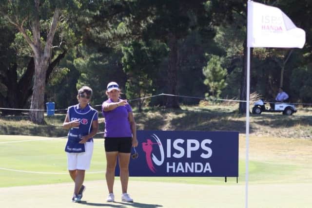Michele Thomson works out a line with her caddie Jo Morley in the second round of the ISPA Handa Australian Women's Open in Adelaide