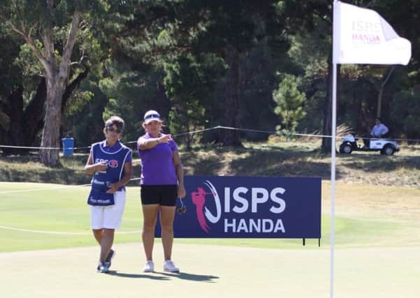 Michele Thomson works out a line with her caddie Jo Morley in the second round of the ISPA Handa Australian Women's Open in Adelaide