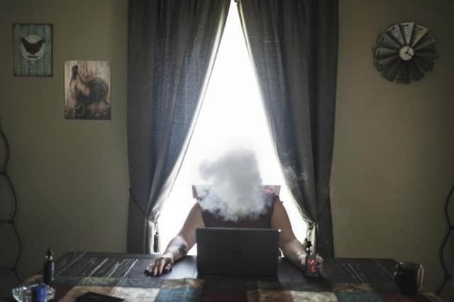 Lorri Cottrill, 45, smokes a e-cigarette in her home in Charleston, West Virginia. She is the leader of the biggest neo-nazi and right wing organization in the US, National Socialist Movement, Virginia. Photographer: Espen Rasmussen/Panos Pictures