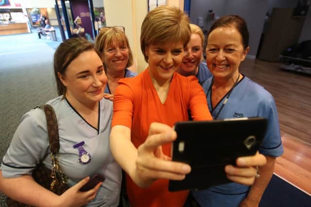 First Minister Nicola Sturgeon takes a selfie with a group of nurses during a visit to the Royal Infirmary of Edinburgh. Picture: PA