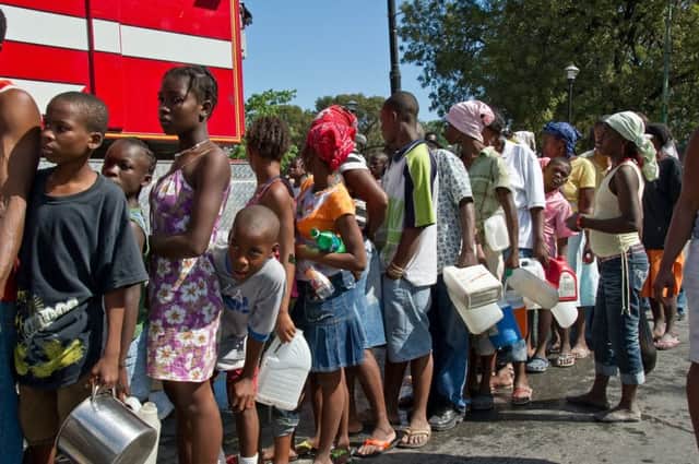 Oxfam has been at the forefront in helping people like these Haitians queueing for water after an earthquake hit Port-Au-Prince in 2010. 
Photograph: Getty Images
