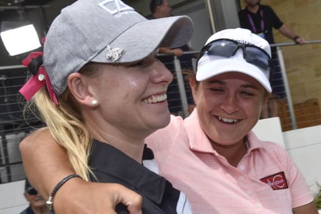 Michele Thomson, right, congratulates fellow LET player Jenny Haglund on winning a Genesis sport car for a hole-in-one in Adelaide