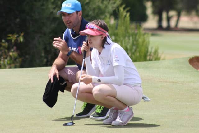 Melrose-born Karis Davidson lines up a putt with her caddie in the third round of the ISPS Handa Australian Women's Ope