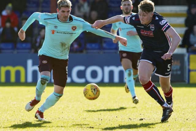Ross Countys Harry Souttar, right, gets a grip on Kyle Lafferty of Hearts during Saturdays 1-1 draw in Dingwall. Picture: SNS.