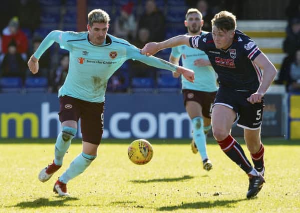 Ross Countys Harry Souttar, right, gets a grip on Kyle Lafferty of Hearts during Saturdays 1-1 draw in Dingwall. Picture: SNS.